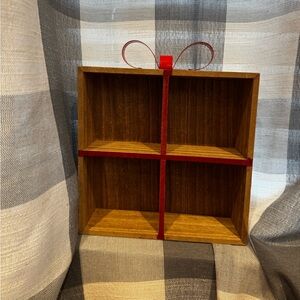Elegant Brown Wooden Wall Shelf with Red Accents